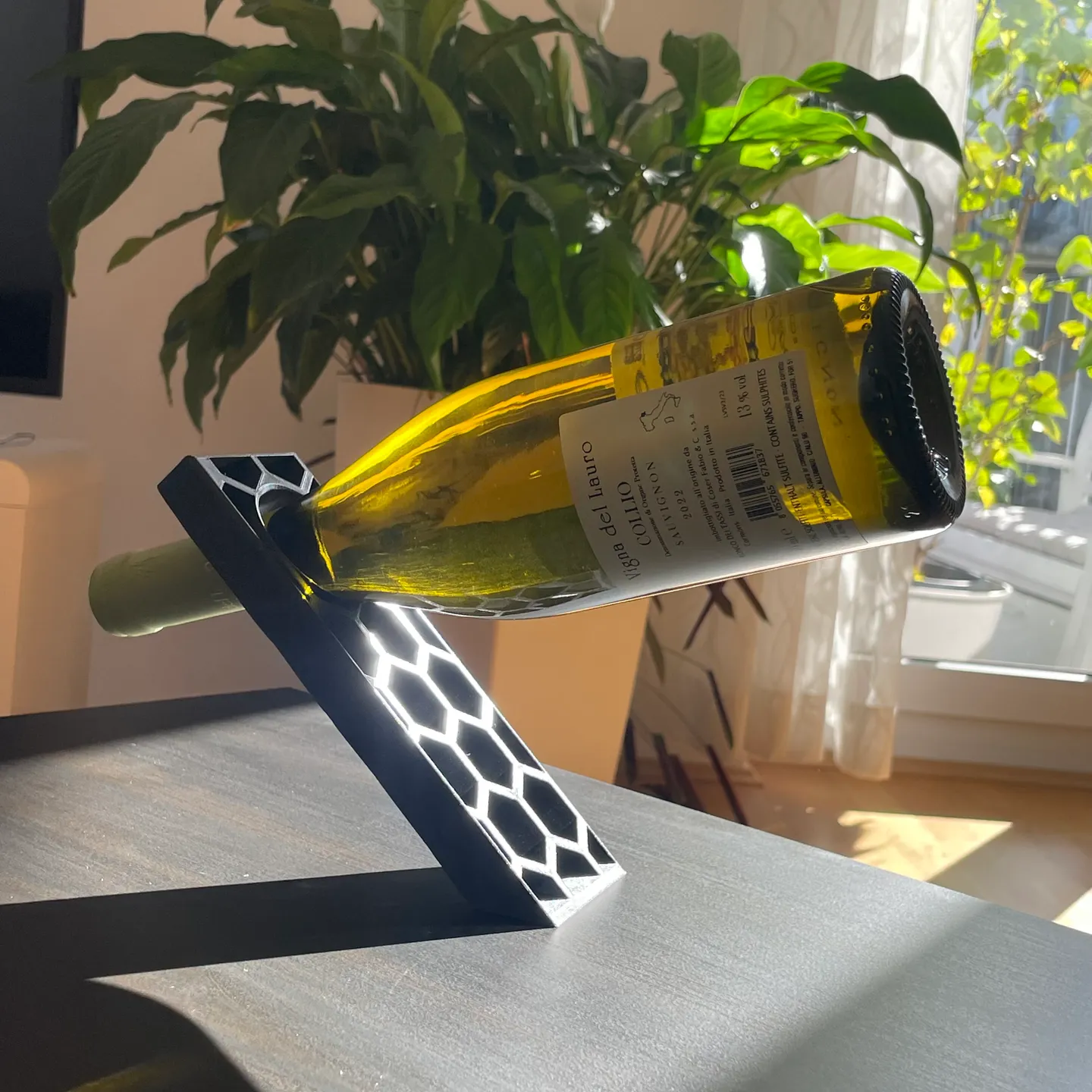 Mateo's 3D-printed stand balancing a wine bottle