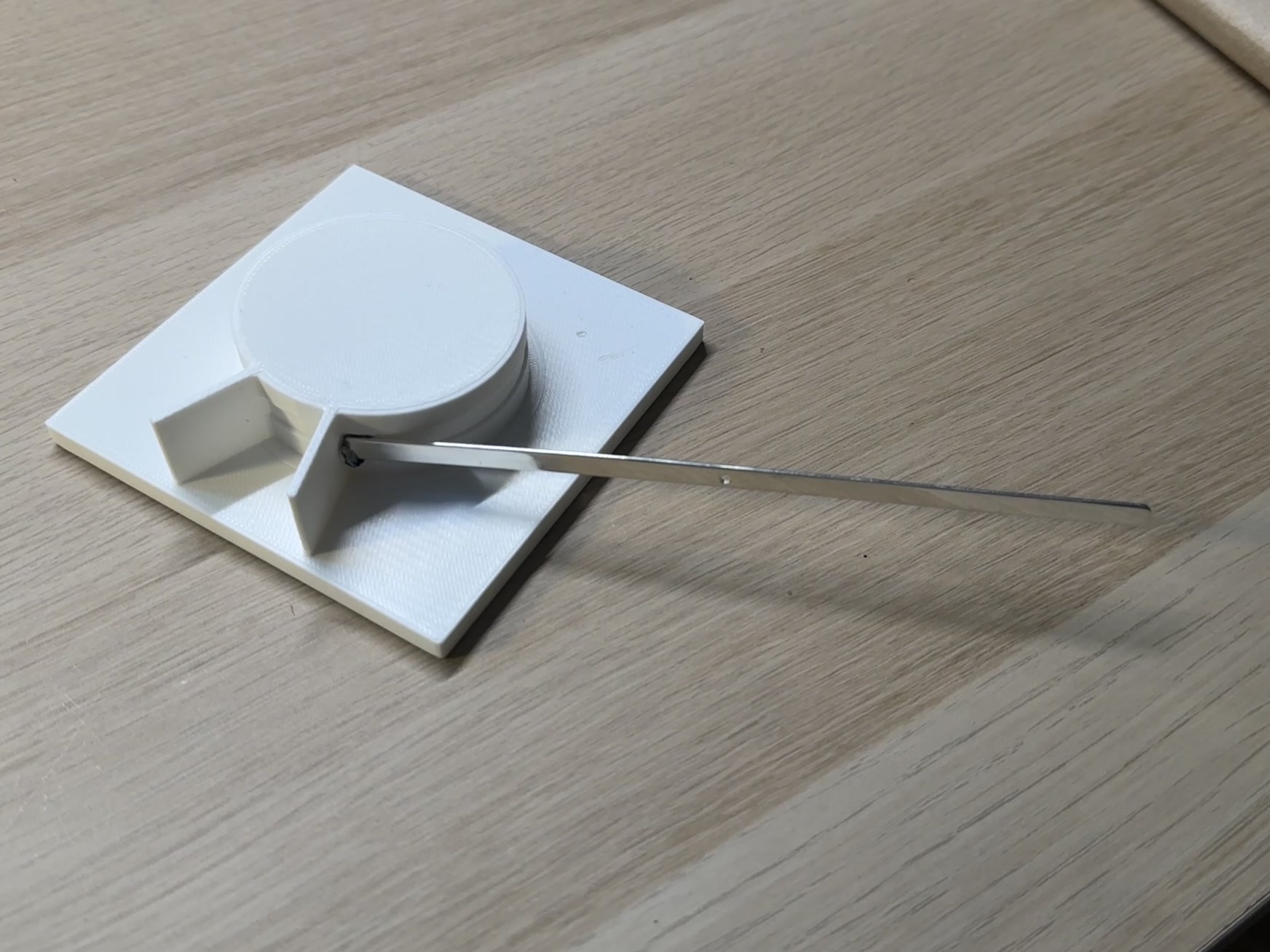 A 3D-printed jig holding the straight metal strip used for the sundial band